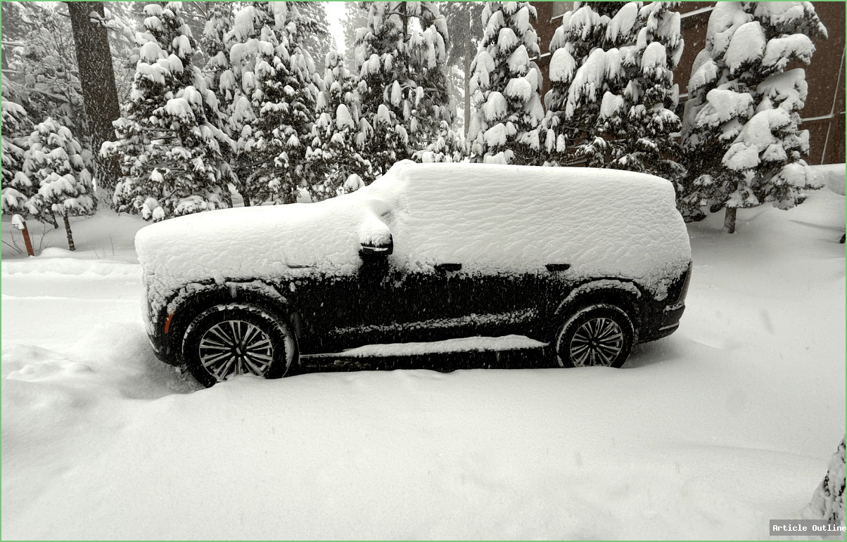 2026 Cadillac Escalade IQL electric SUV in snowy driveway